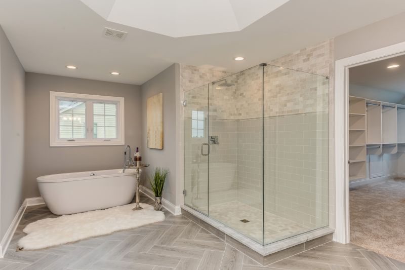 Renovated bathroom with a glass enclosure and modern lighting